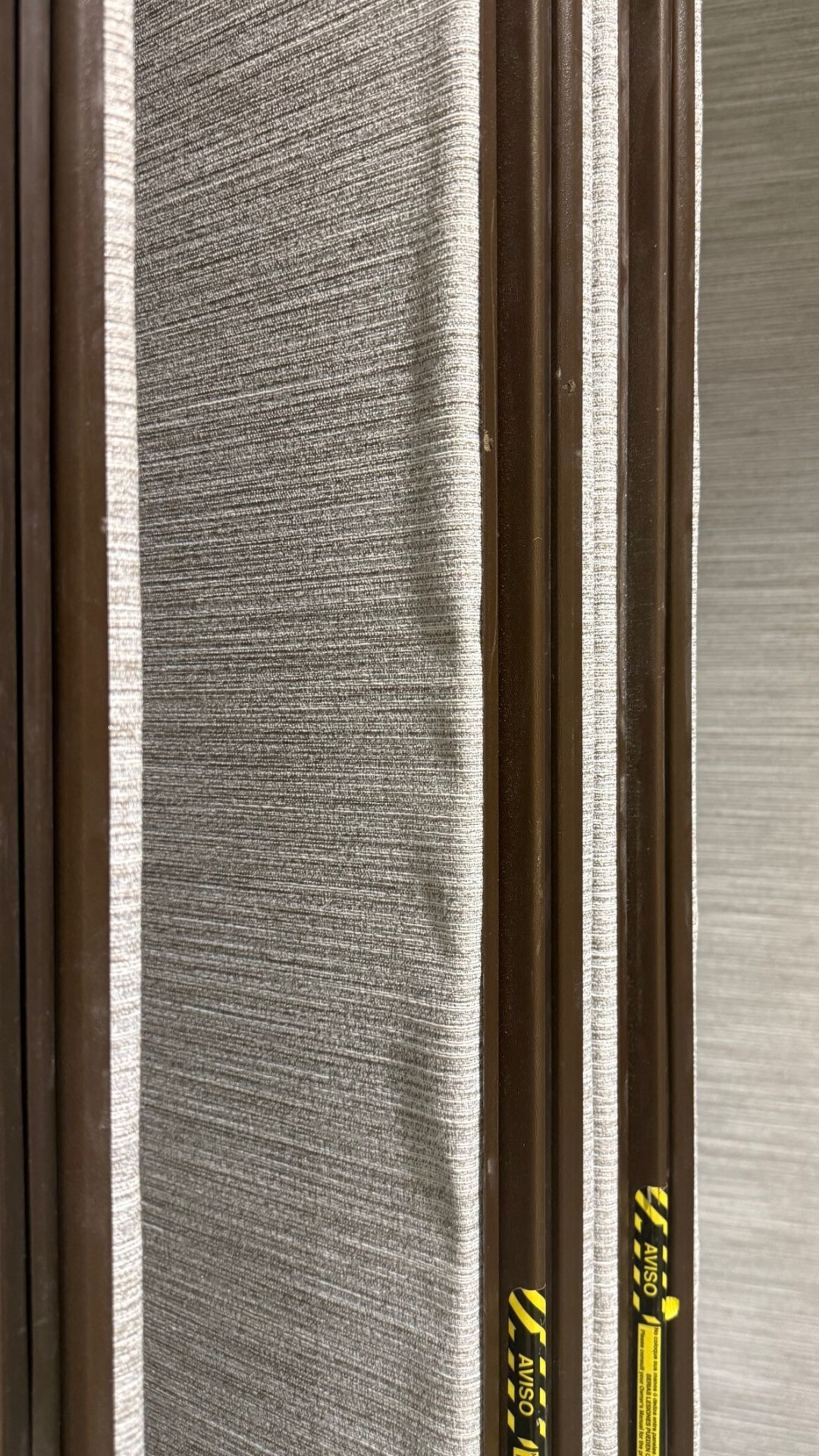 Operable wall with wallcovering that is bubbling and separating from the face.